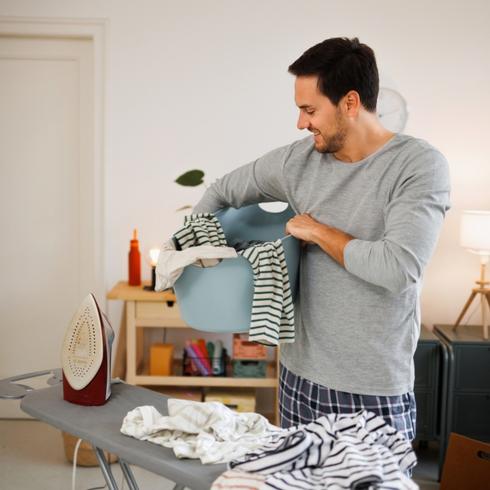 A young man folding laundry - Habits-of-People-With-Super-Clean-Houses