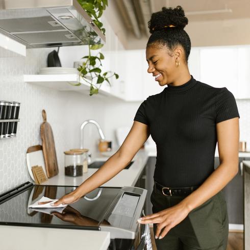 Woman Wiping Down Counter - Habits-of-People-With-Super-Clean-Houses