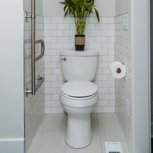 A clean white toilet stall