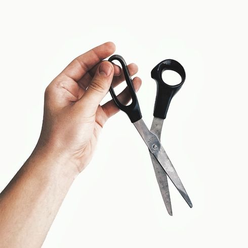person holding scissors