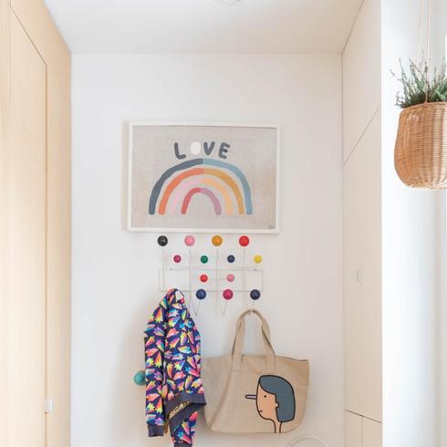 Entry way with art and colourful hooks