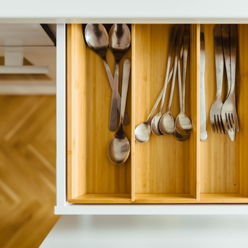 A kitchen utensils drawer with like items stored together.