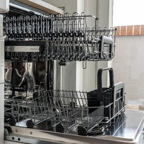 An open dishwasher with the trays pulled out
