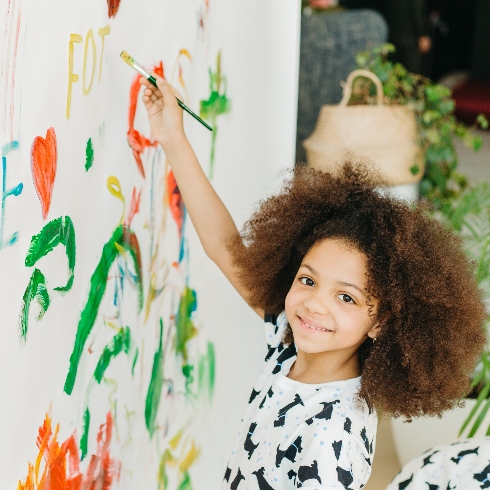 A child painting on a wall