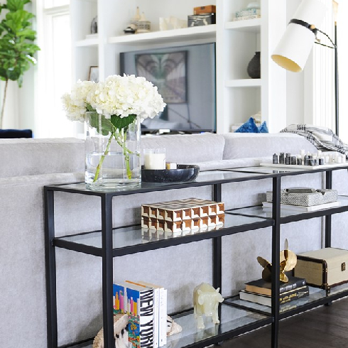 Chunky white shelving is a smart way to corral clutter (and display gorgeous pieces of artwork).