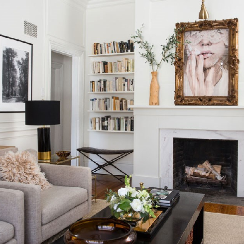 Parisian-chic living room with high ceilings, mouldings and simple shelving.