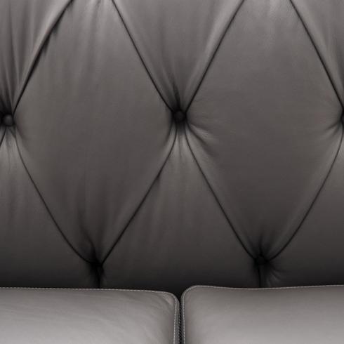 close up of grey leather tufted sofa