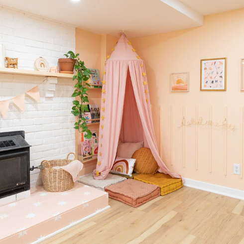 Pink reading nook with curtain in a child's bedroom