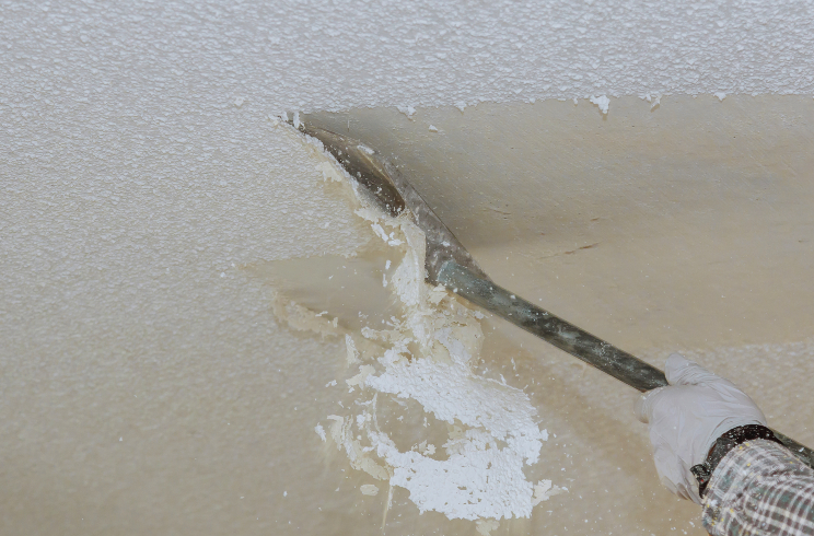 Take off in the popcorn ceiling home wall texture removal - stock photo