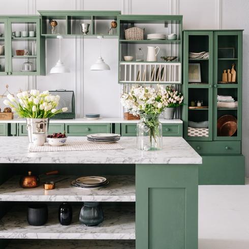 Green kitchen with white countertops
