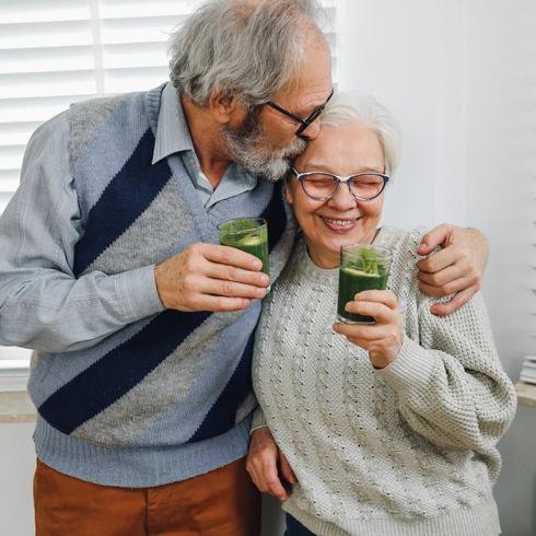 Senior couple drinking green smoothies