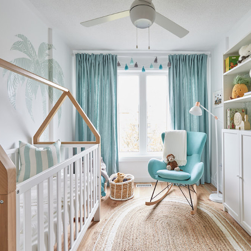 blue and white nursery with blue drapes and a cozy blue chair