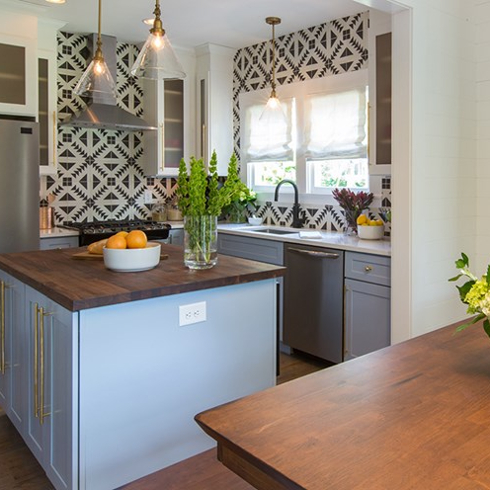 modern boho kitchen with lavender cabinets, quartz counters and centre island
