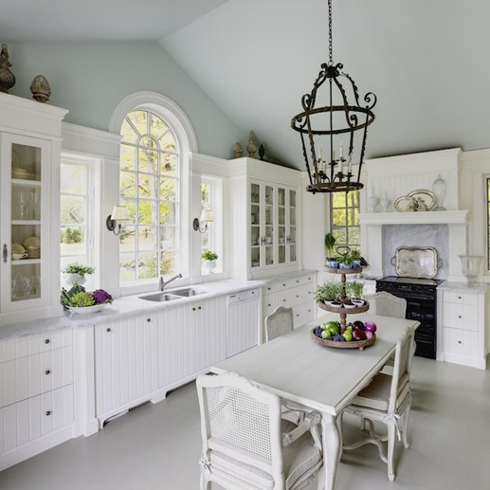 white kitchen with baby blue ceiling and ornate windows