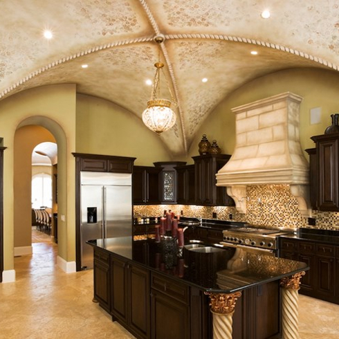 formal kitchen with dark wood cabinets and ornate ceiling