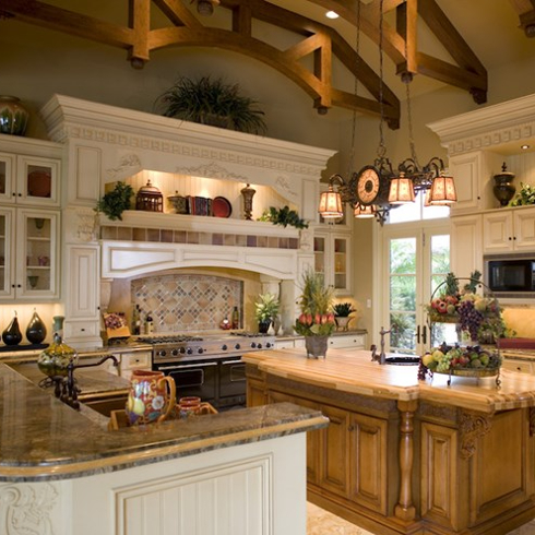 traditional beige and wood kitchen with high ceiling beams and centre island