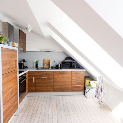 white and wood kitchen with angled roof on one side