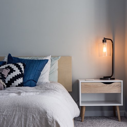 bedroom with lamp on nightstand