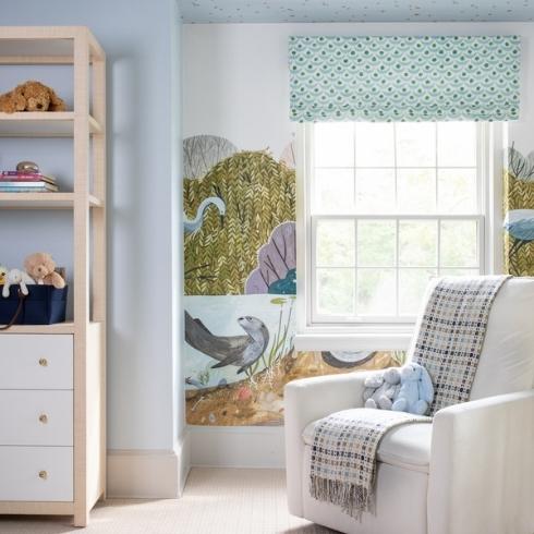 Wildlife mural in nursery with pale blue walls and ceiling