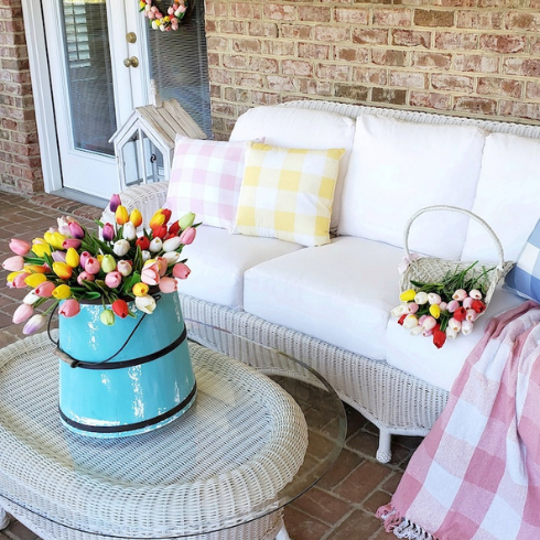 Tulips on spring porch with wicker furniture