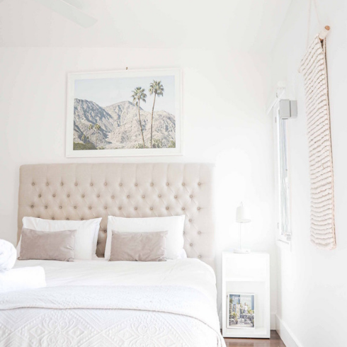 white bedroom with white ceiling and white bed