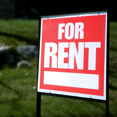 Red For Rent sign outside of property