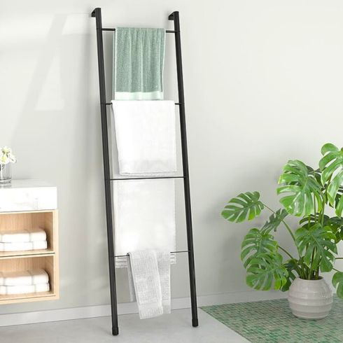 Minimal wood bathroom with black towel ladder on wall