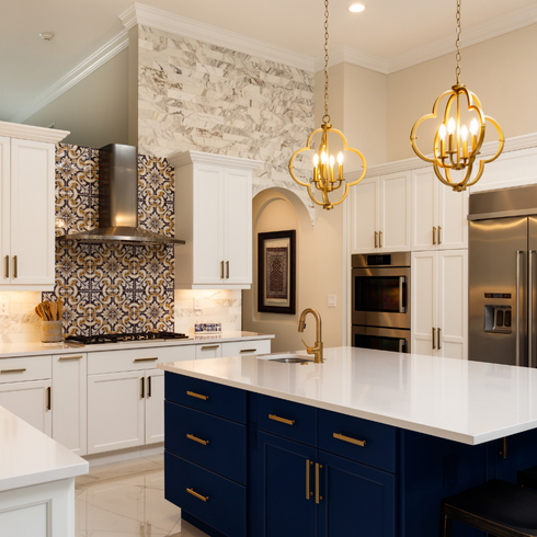 Large kitchen island with gold pendant lights