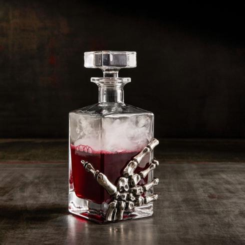 skeleton hand wrapped around a decanter
