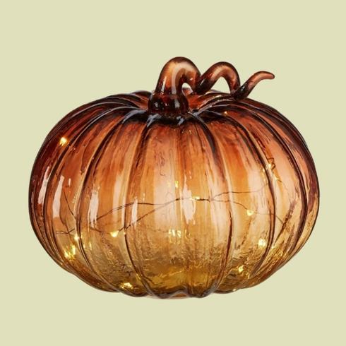 Orange and gold glass pumpkin with string lights