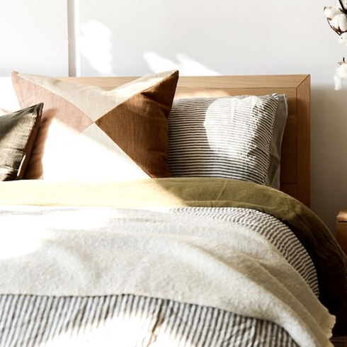 cozy striped bed with a mix of pillows