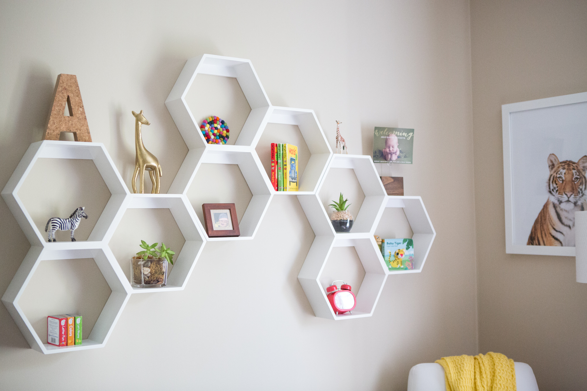 White honeycomb shelving displaying objects in kids' room.