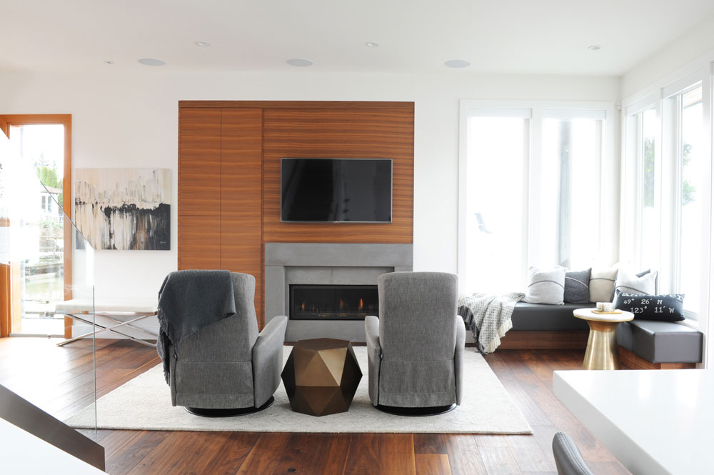Gold and grey commingle in this living room with a striking wood wall and built-in fireplace.