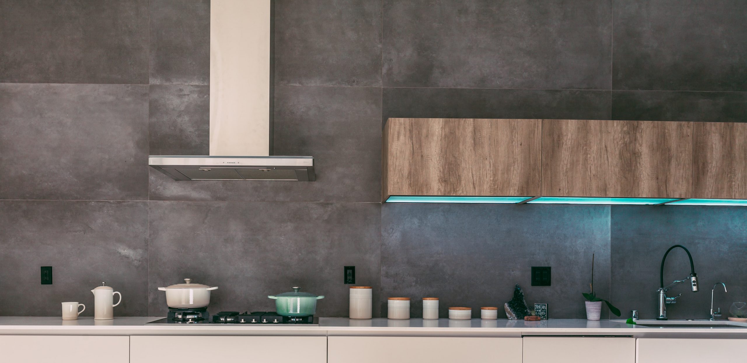 Modern kitchen with floating cabinets with turquoise lighting