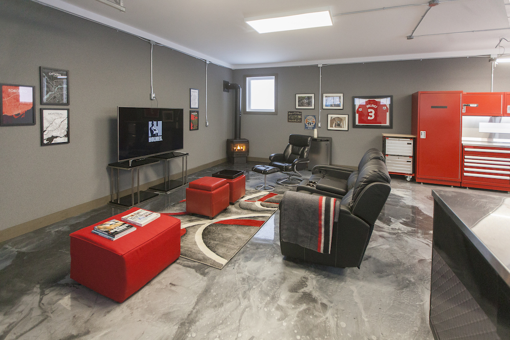 Modern interior of a fully renovated garage with TV and red accents