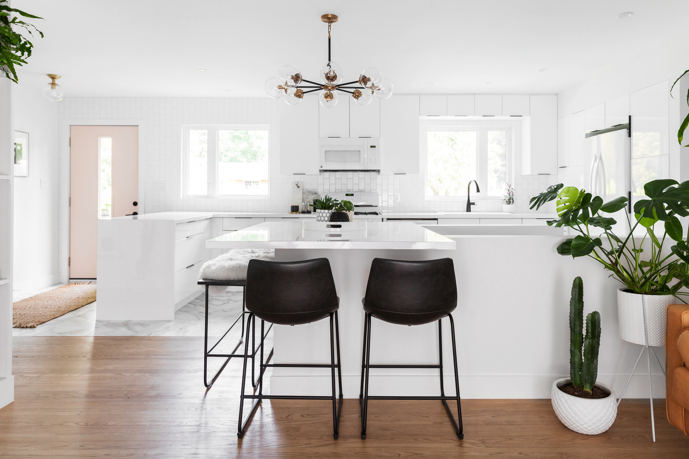 Modern white kitchen with black and brass accents