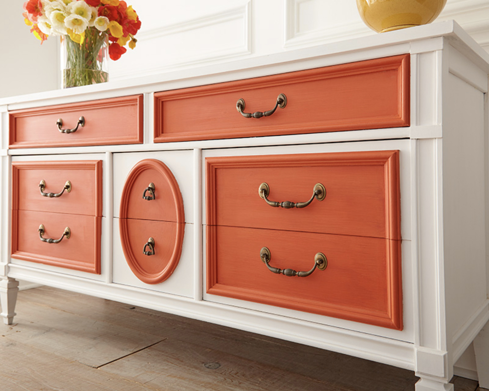 White dresser painted with BEHR Chalk Decorative Paint topped with a vase full of yellow, red and orange poppies