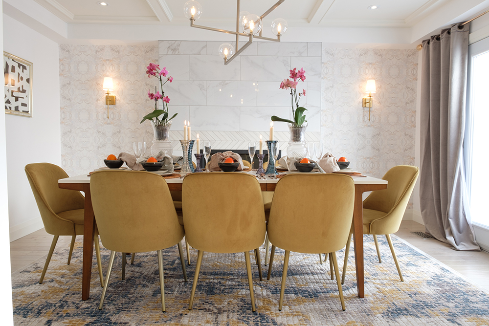 Chic dining room with yellow velvet chairs and a retro globe chandelier