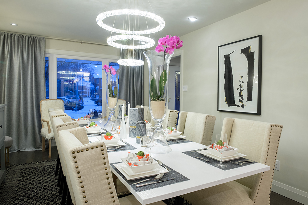 Glamourous dining room with white quartz topped table and high backed upholstered chairs