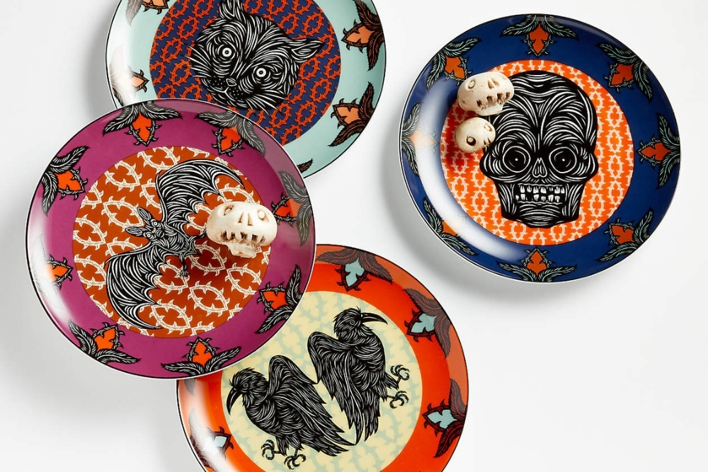 Four colourful salad plates with a bat, skull, wolf and crow design.
