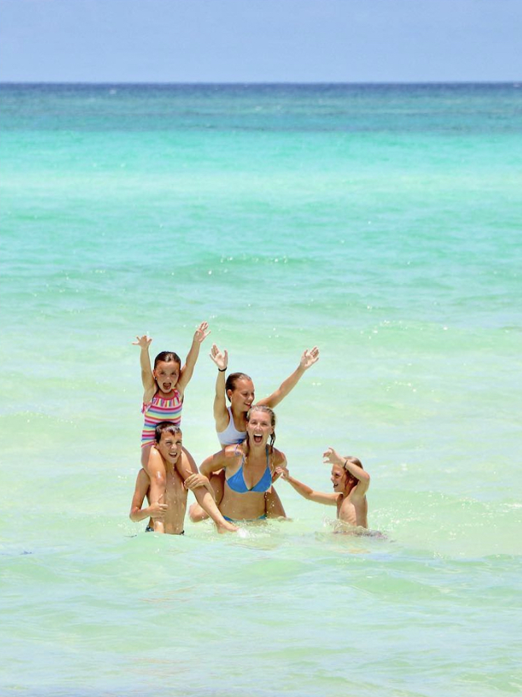Sarah Baeumler and her four children play in the ocean off of South Andros Island