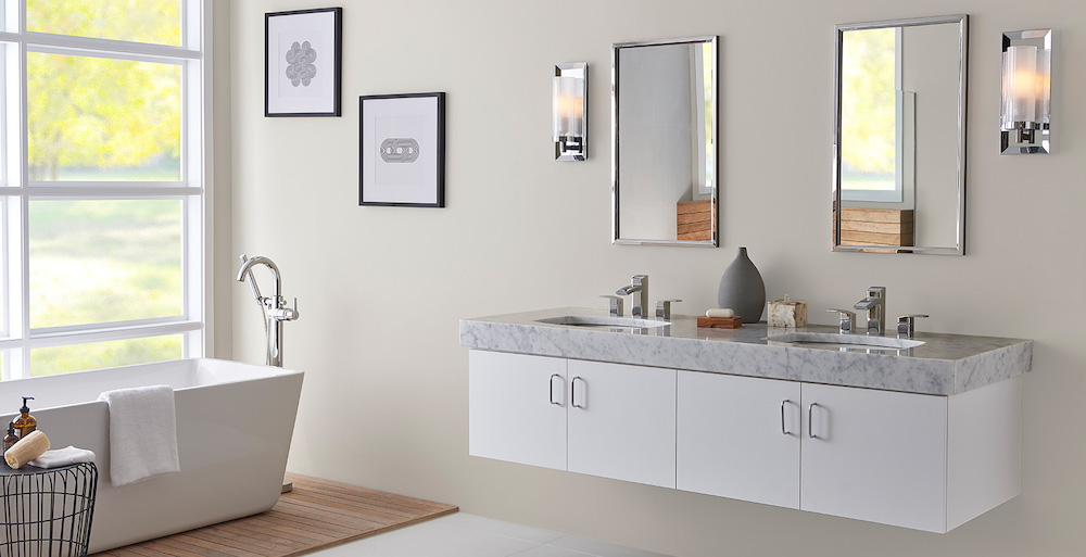 Modern white bathroom with rectangular standalone bathtub in front of large windows, a double sink floating vanity, two wall mirrors, two wall sconces, and walls painted with BEHR Dove HDC-MD-21