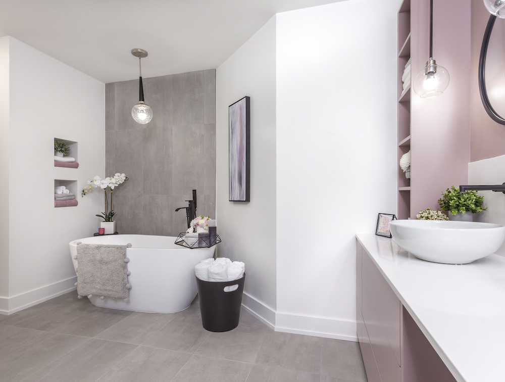 A bathroom with dusty-rose cabinets and smoky-grey floor tiles