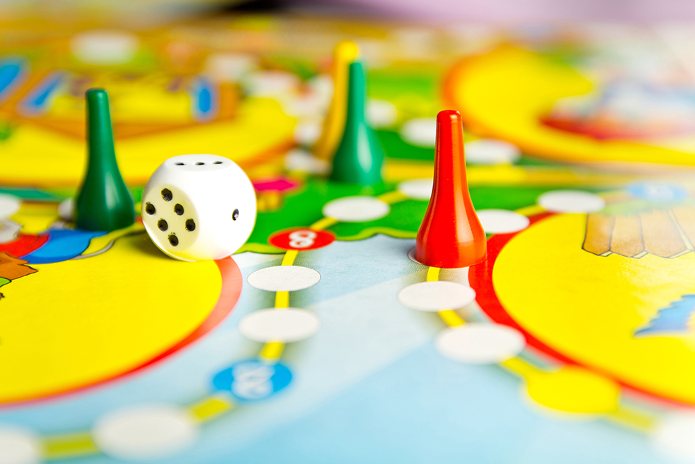 Board games for the home. Yellow, green and red plastic chips and dice on Board games for children . Selective focus