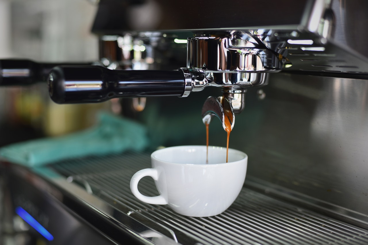 Espresso Machine pouring a shot into a small white cup