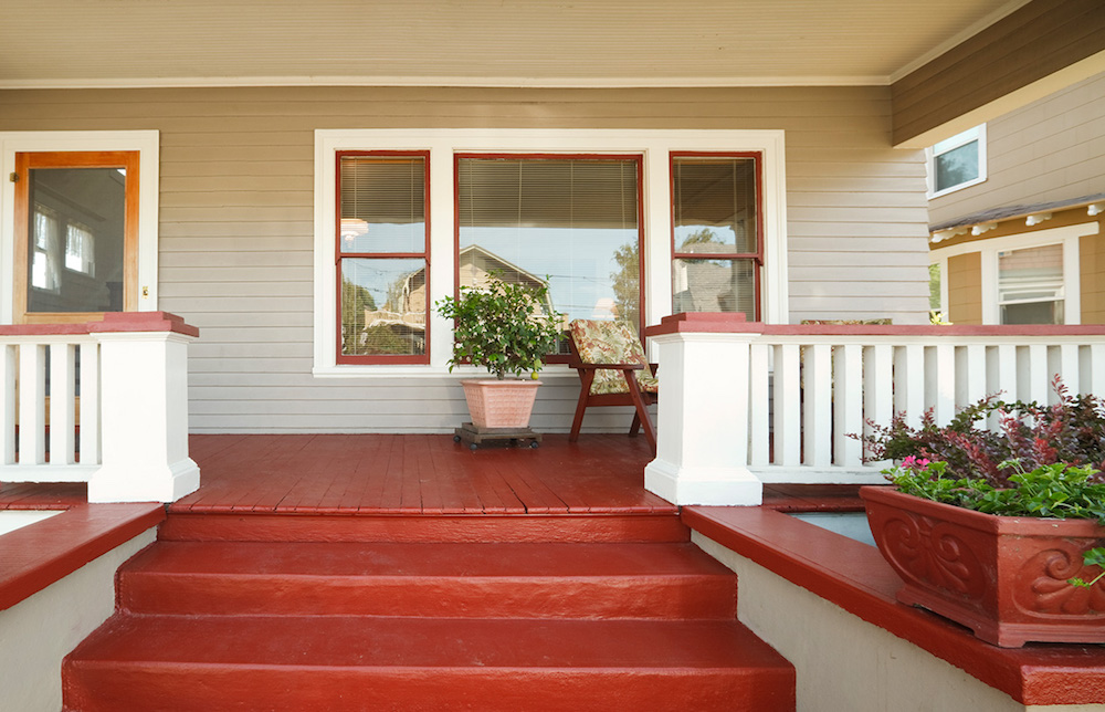beige and white home exterior with red front porch and stairs