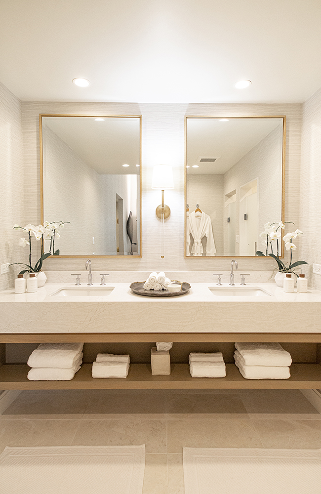 A sleek bathroom vanity with two panes of mirrors in elegant frames