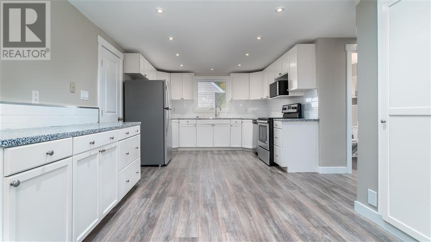 Spacious, clean kitchen space with all-new appliances, flooring and backsplash