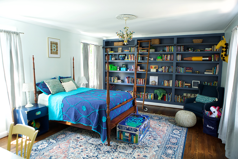 Kids bedroom with built-in bookcase wall.