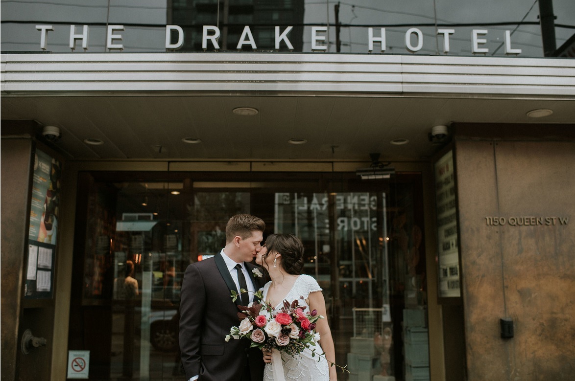 Couple kissing in front of The Drake Hotel